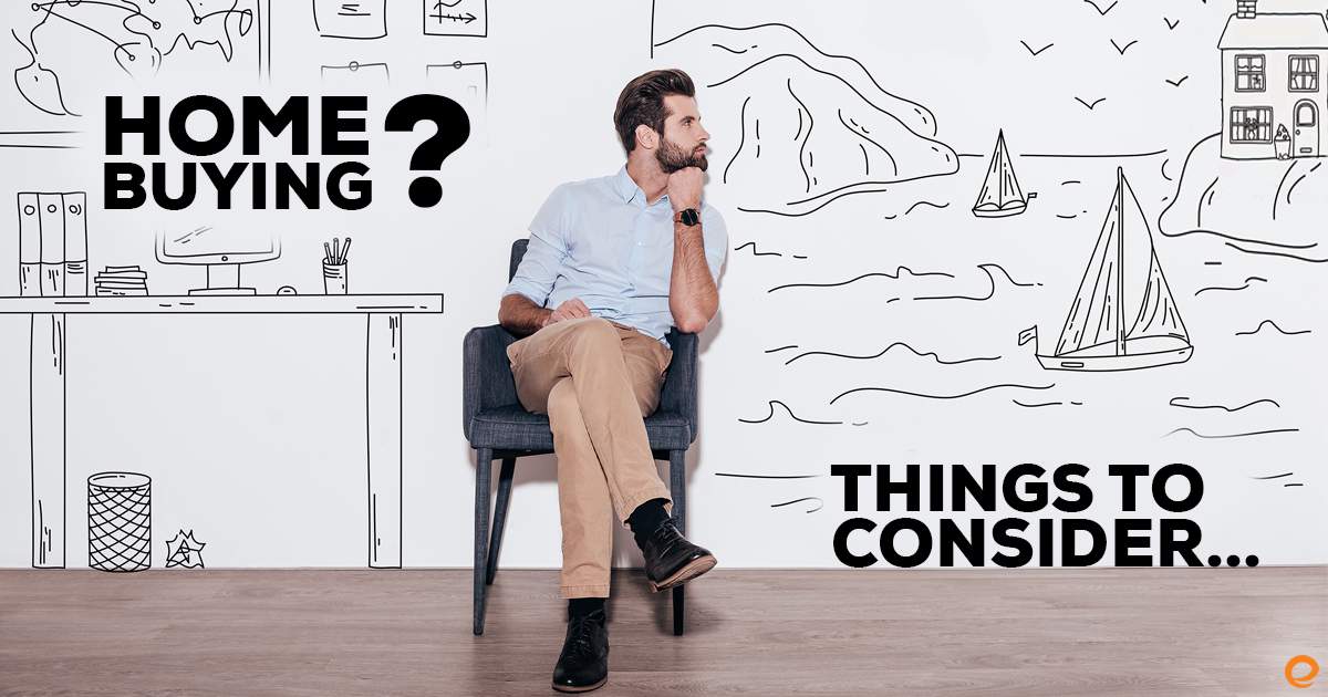 Man sitting in front of a wall drawing of a house